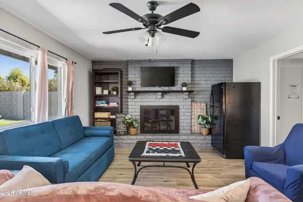 a living room with furniture a flat screen tv and a fireplace