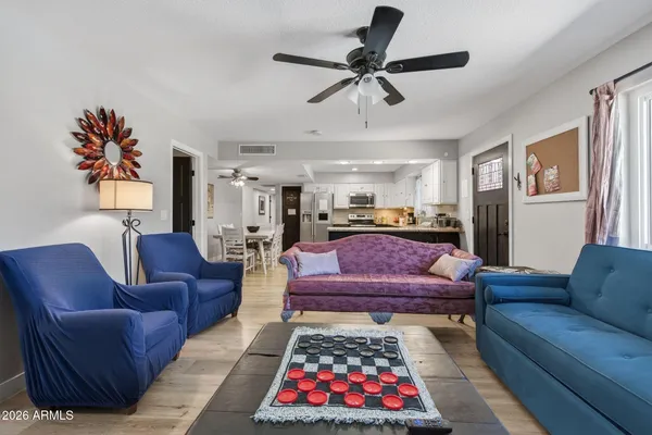 a living room with furniture ceiling fan and a rug