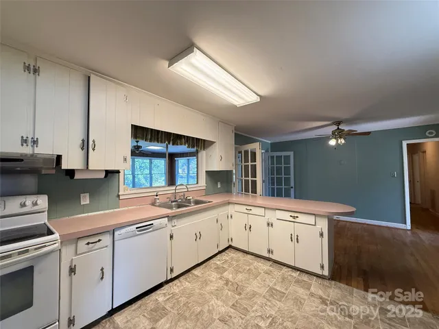 a kitchen with a sink stove and cabinets