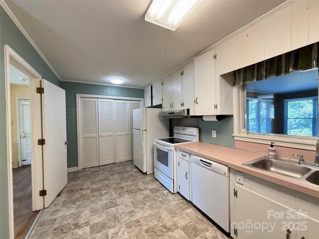 a open kitchen with kitchen island a sink stove and refrigerator