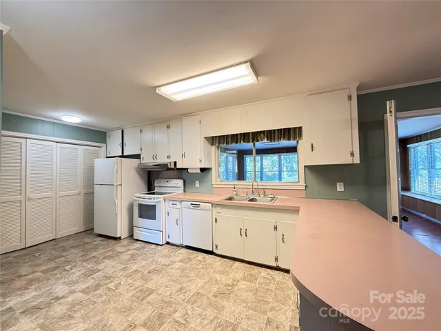a kitchen with refrigerator and cabinets