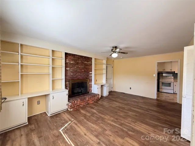 wooden floor in an empty room with a fireplace