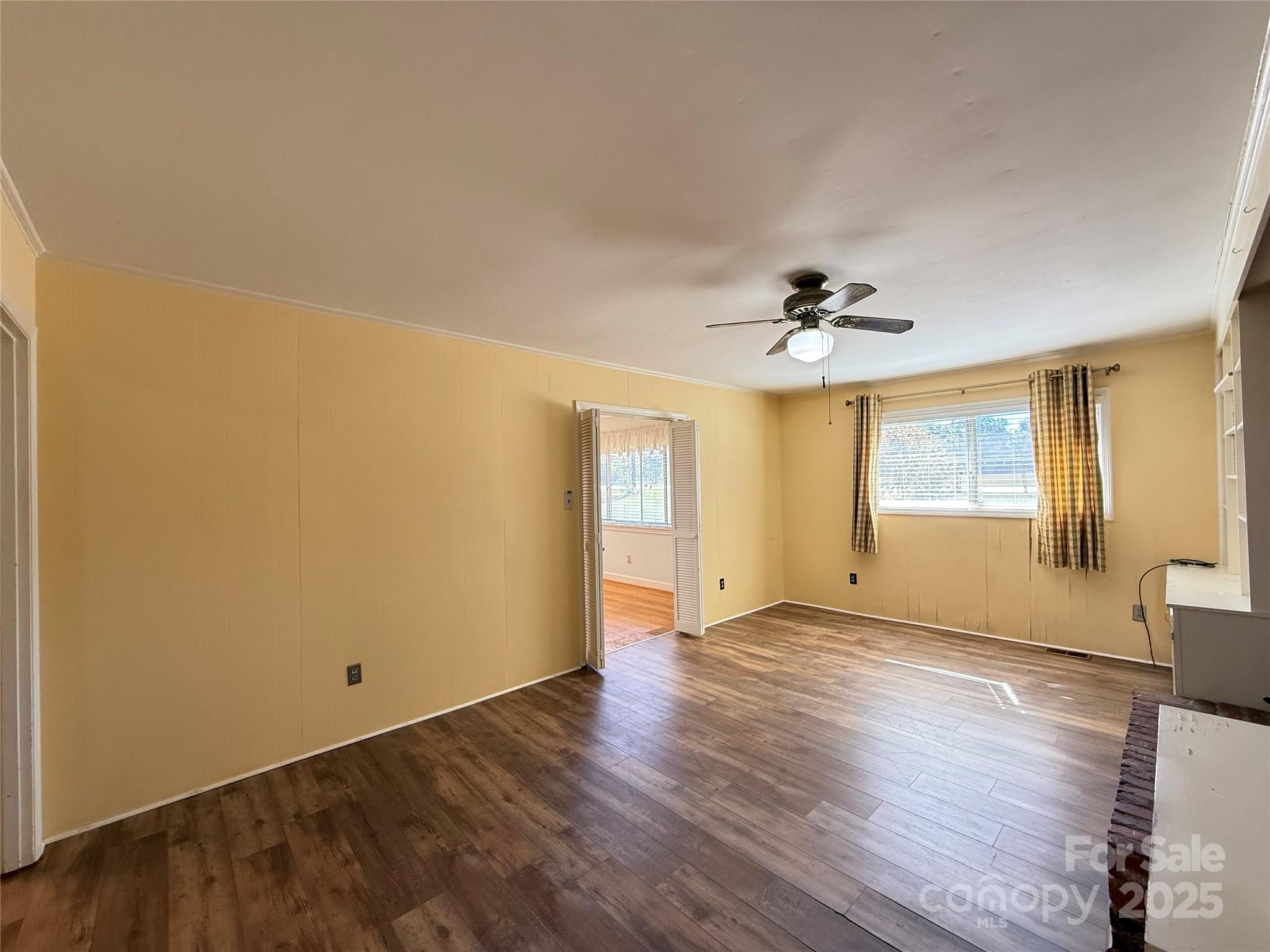 115 Chester Avenue Great Falls, SC 29055 - Photo 18 of 32 a view of an empty room with wooden floor and a window