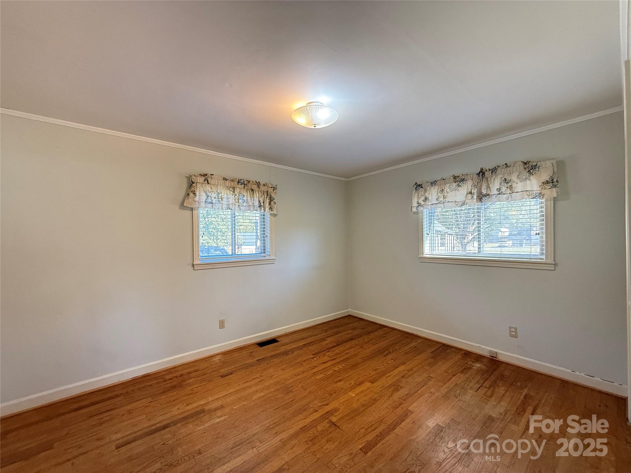 115 Chester Avenue Great Falls, SC 29055 - Photo 29 of 32 a view of an empty room with wooden floor and a window