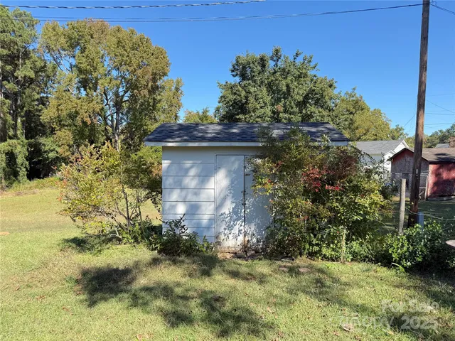 a view of a wooden door with a yard