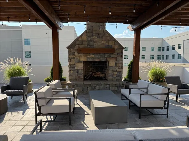 a living room with furniture and floor to ceiling windows