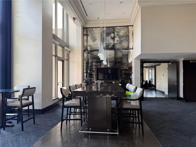 a living room with furniture a flat screen tv and a large window
