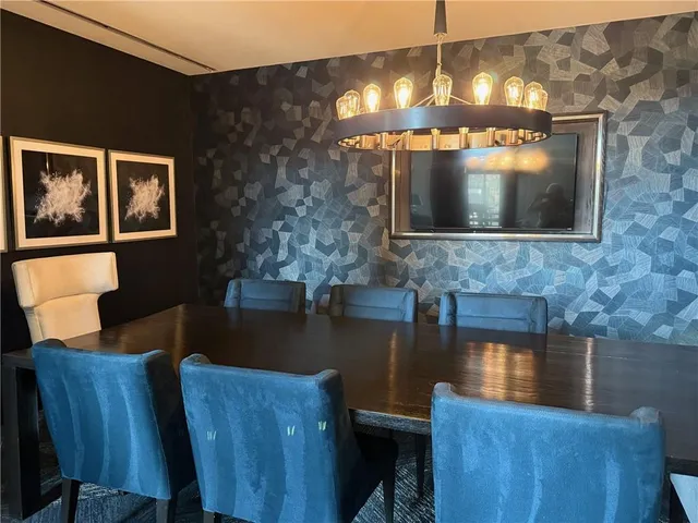 a view of a living room with furniture and wooden floor