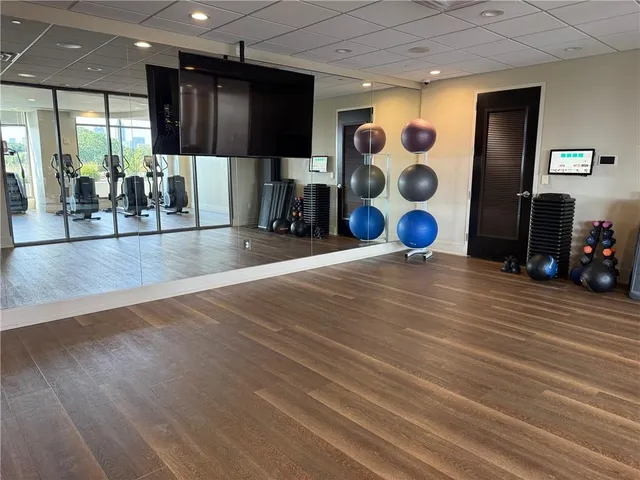 a room with gym equipment and a large window