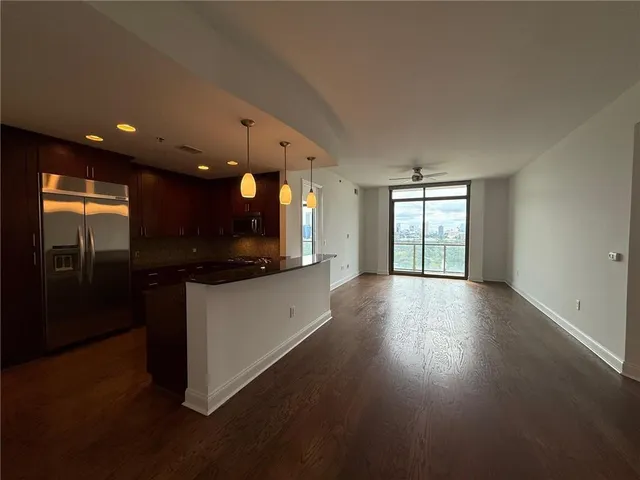 a utility room with wooden floor washer and dryer