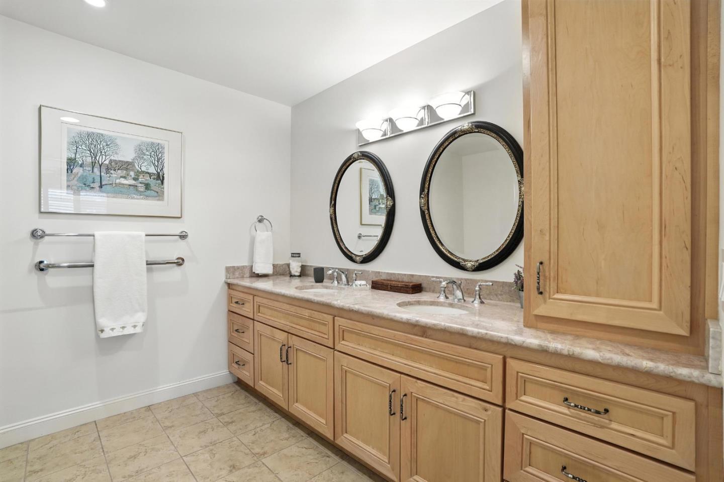 10 Crystal Springs Road, Unit 1507 San Mateo, CA 94402 - Photo 16 of 33 a bathroom with a granite countertop toilet a sink and a mirror