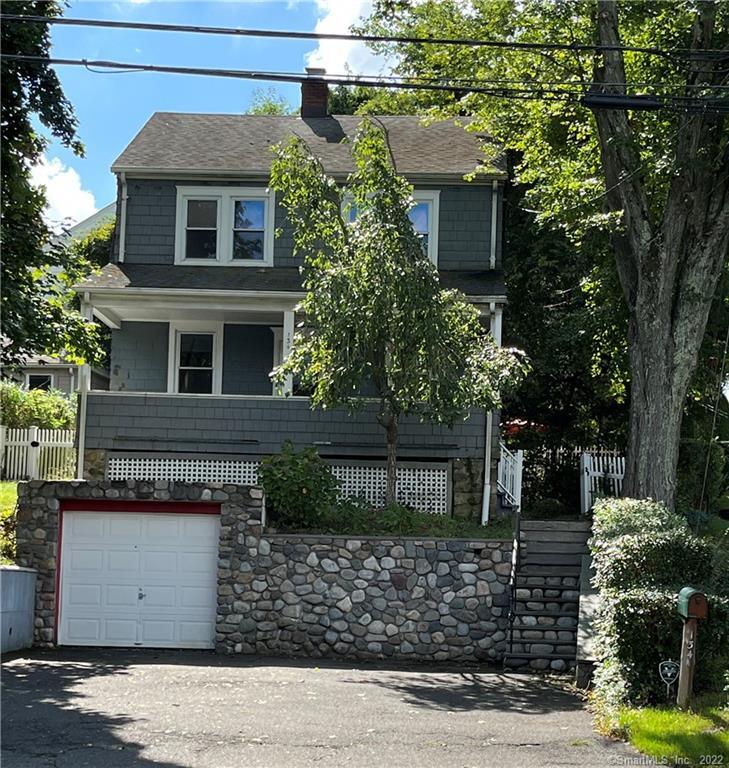 134 Toms Road Stamford, CT 06906 - Photo 1 of 1 a front view of a house with garden