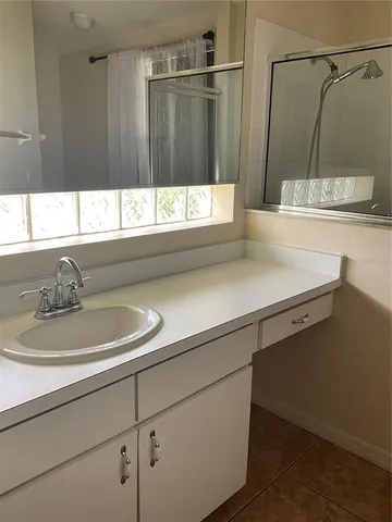 a bathroom with a sink a toilet and shower curtain