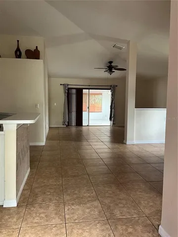 a view of a livingroom with a ceiling fan and window