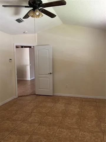 a view of a livingroom with a ceiling fan and window