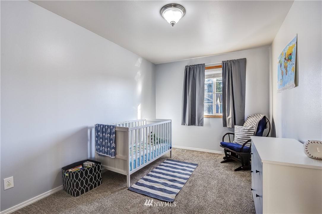 3315 189th Place Southeast Bothell, WA 98012 - Photo 17 of 28 a living room with furniture a baby crib and a couch