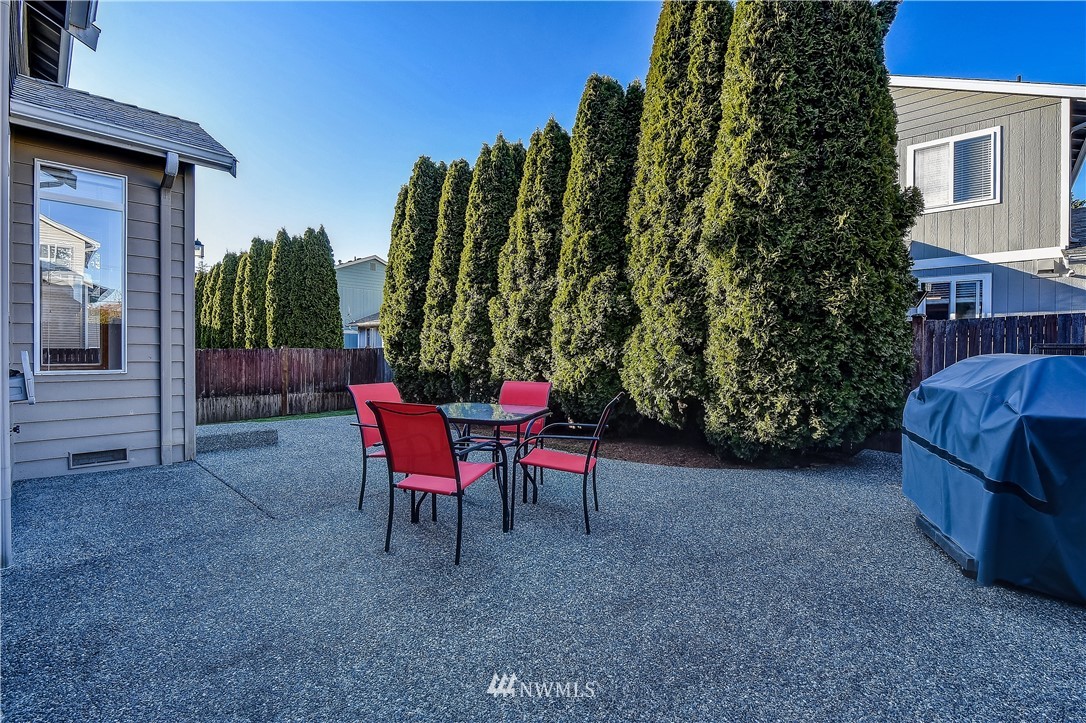 3315 189th Place Southeast Bothell, WA 98012 - Photo 24 of 28 a view of a chairs and table in the back yard of the house