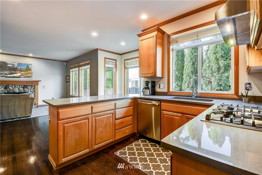 3315 189th Place Southeast Bothell, WA 98012 - Photo 7 of 28 a kitchen with stainless steel appliances granite countertop a stove a sink and a microwave