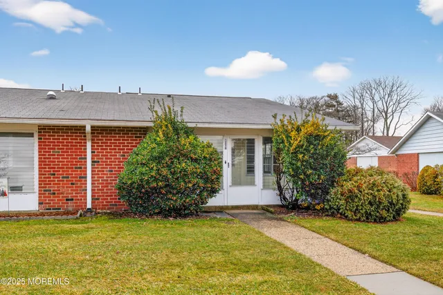 a view of a hallway with wooden floor and windows