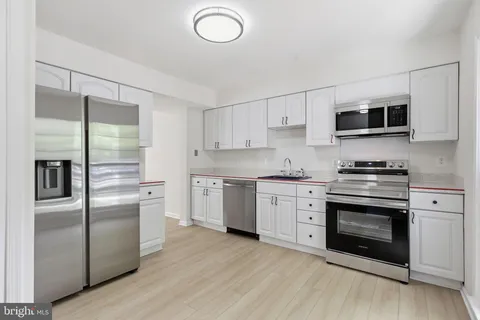a kitchen with a refrigerator stove and microwave