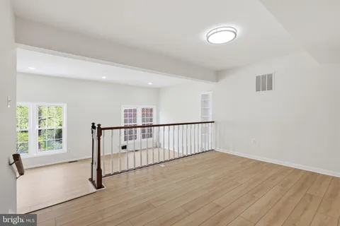 a view of a room with wooden floor and windows