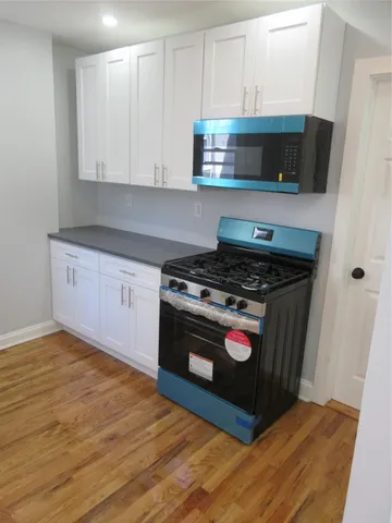 a kitchen with stainless steel appliances granite countertop a stove and a microwave