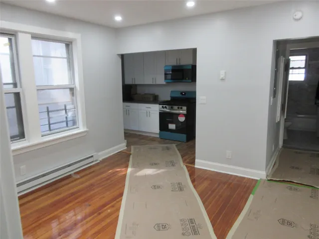 a view of kitchen with refrigerator and window