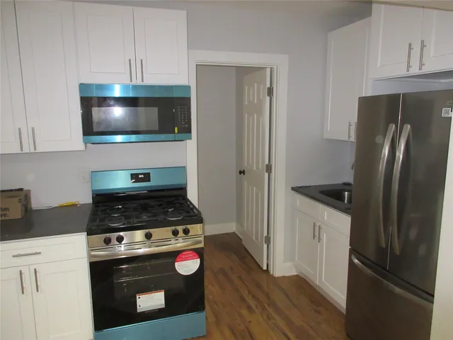 a kitchen with a stove and a refrigerator