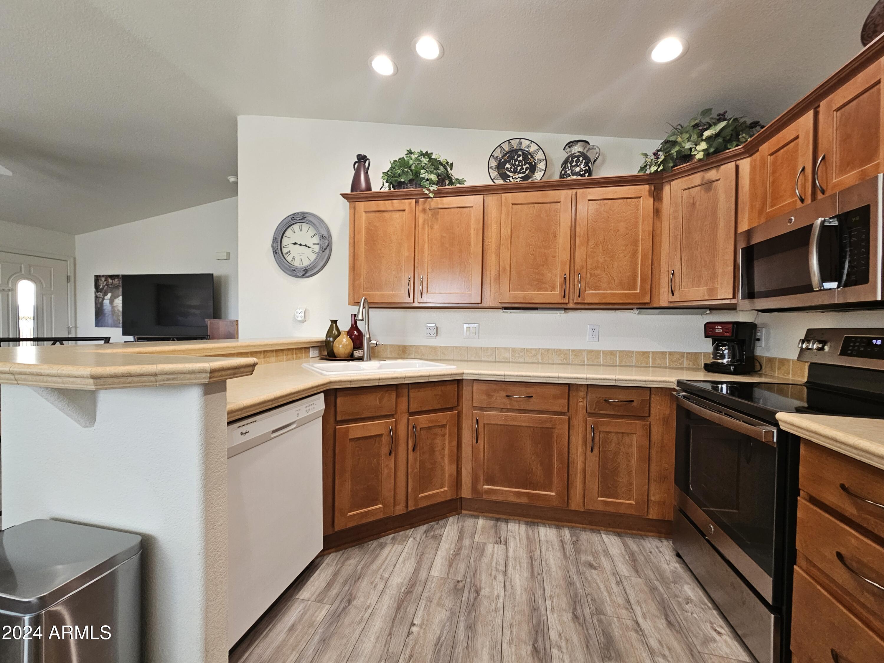 650 North Hawes Road, Unit 4412 Mesa, AZ 85207 - Photo 12 of 48 a kitchen with stainless steel appliances granite countertop a stove a sink and a microwave