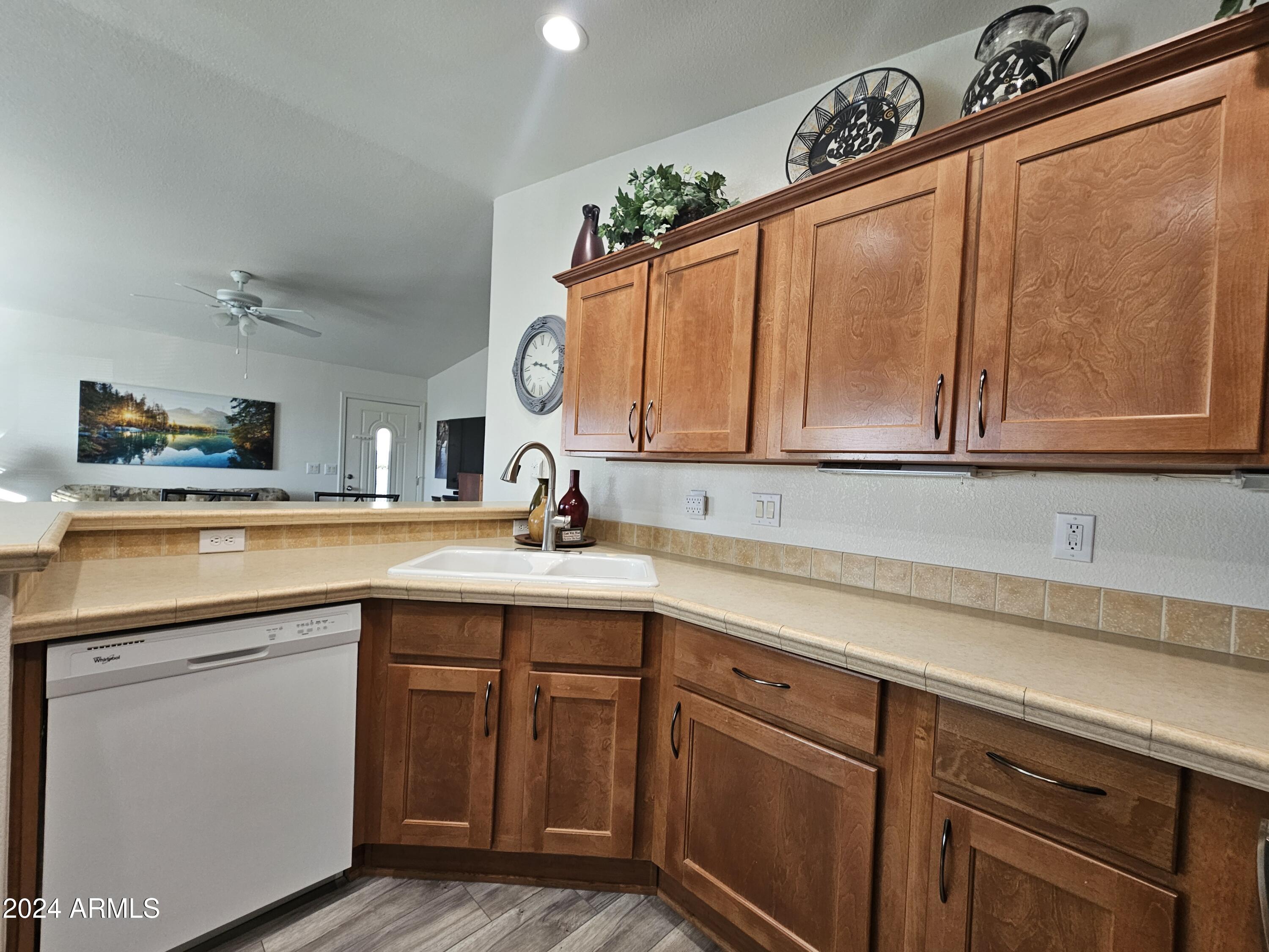 650 North Hawes Road, Unit 4412 Mesa, AZ 85207 - Photo 15 of 48 a kitchen with a sink cabinets and a window