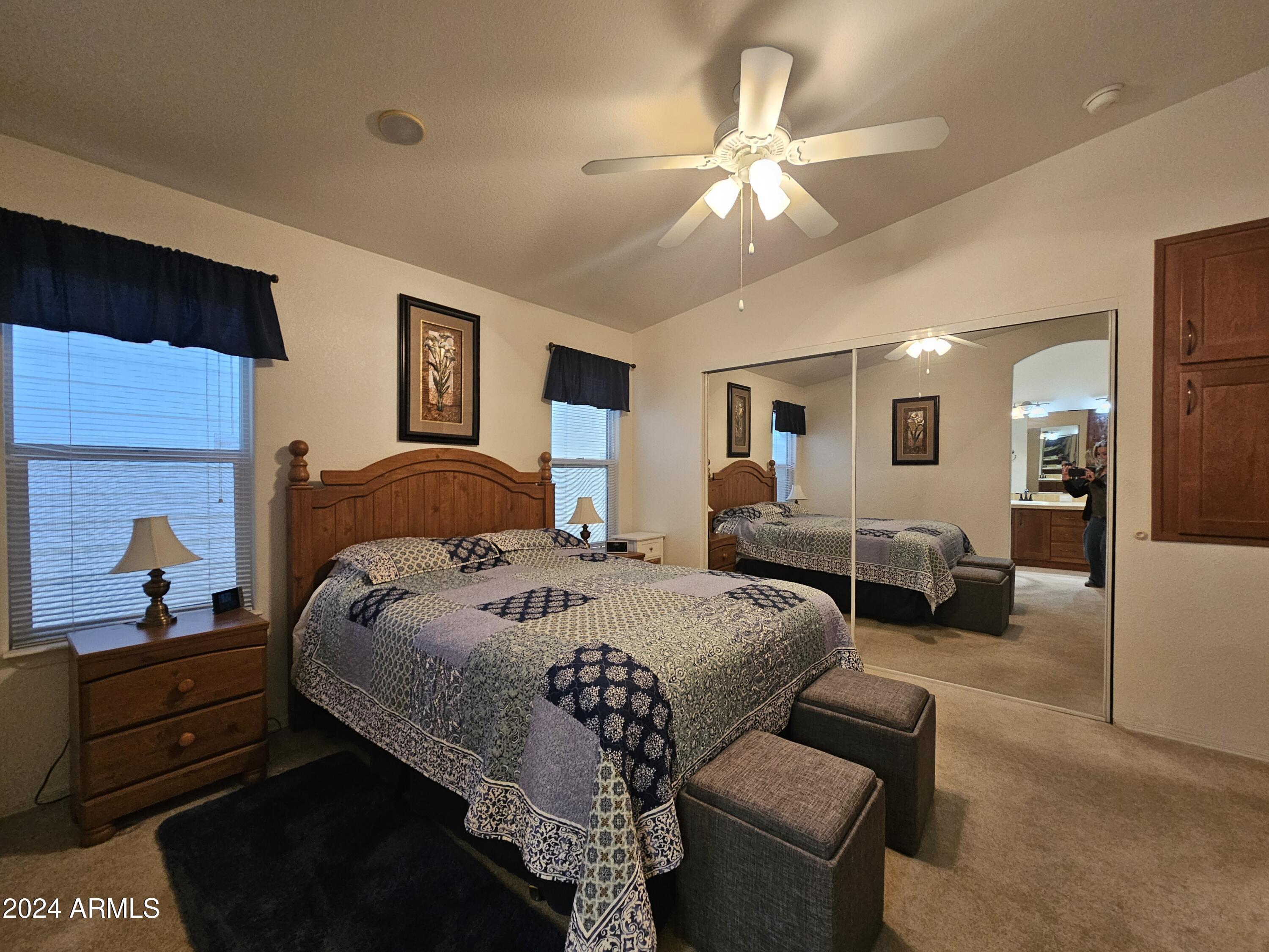650 North Hawes Road, Unit 4412 Mesa, AZ 85207 - Photo 18 of 48 a spacious bedroom with a bed a couch and dresser