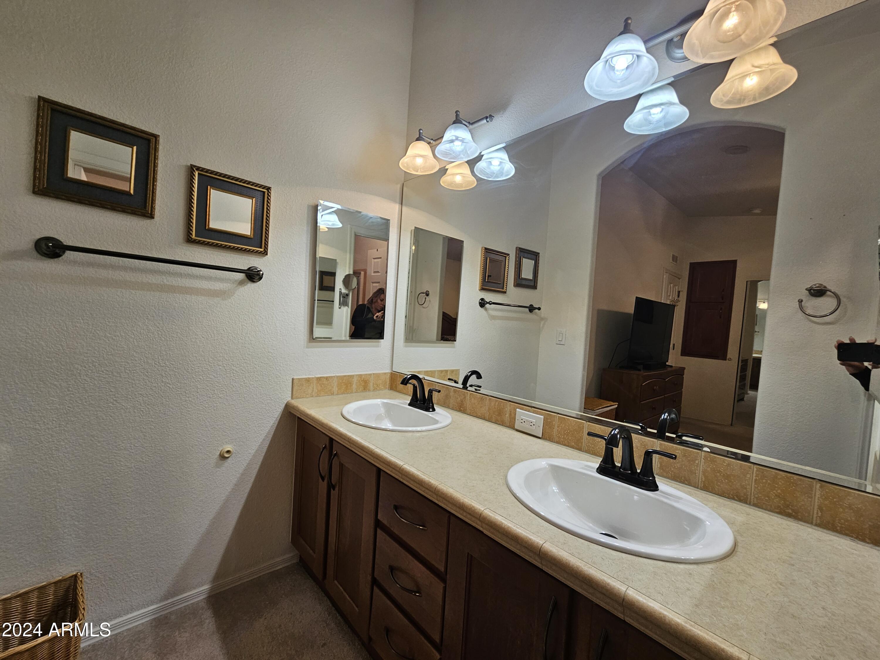 650 North Hawes Road, Unit 4412 Mesa, AZ 85207 - Photo 22 of 48 a bathroom with a double vanity sink and a mirror