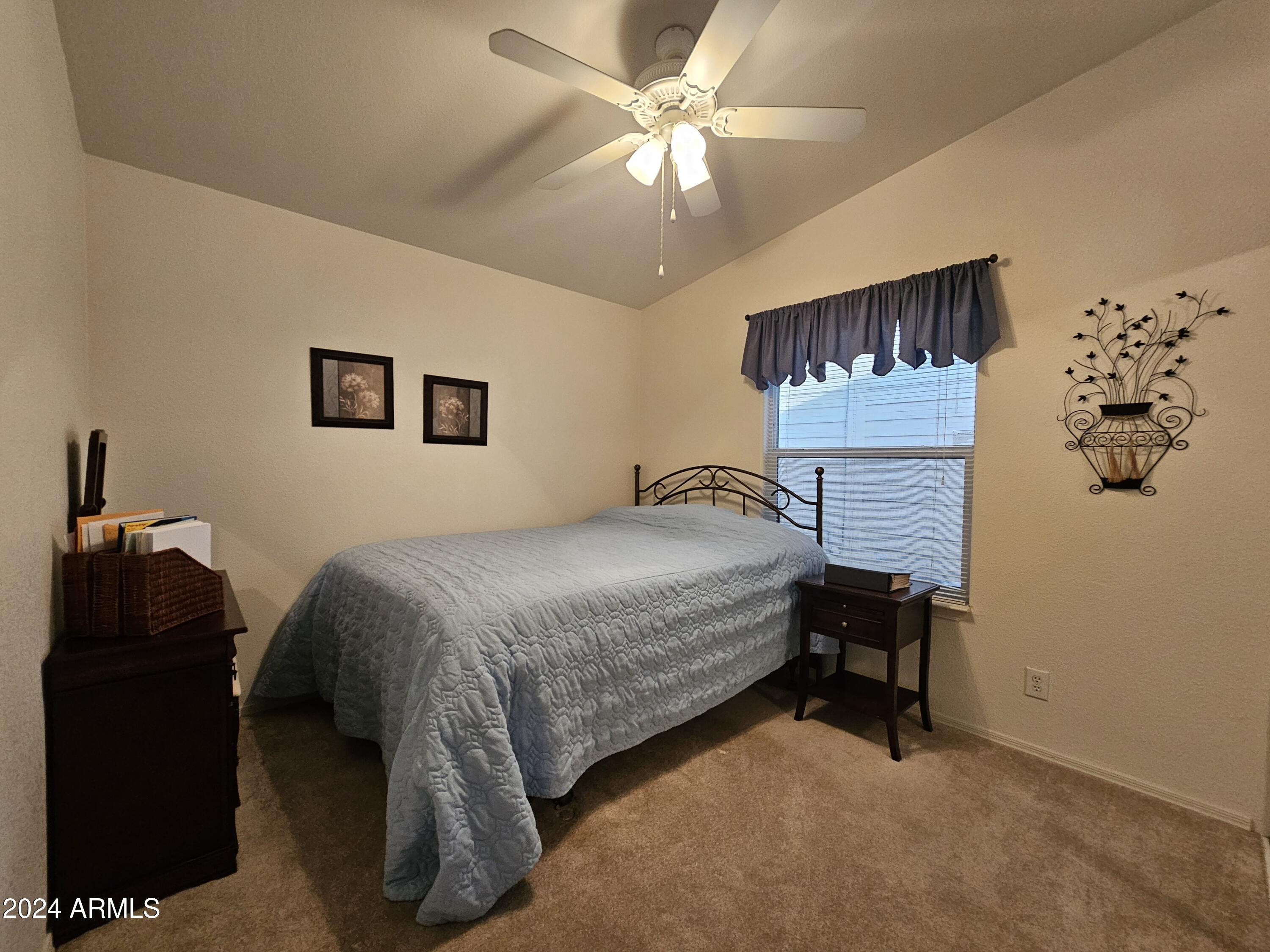 650 North Hawes Road, Unit 4412 Mesa, AZ 85207 - Photo 24 of 48 a bedroom with a bed and a table