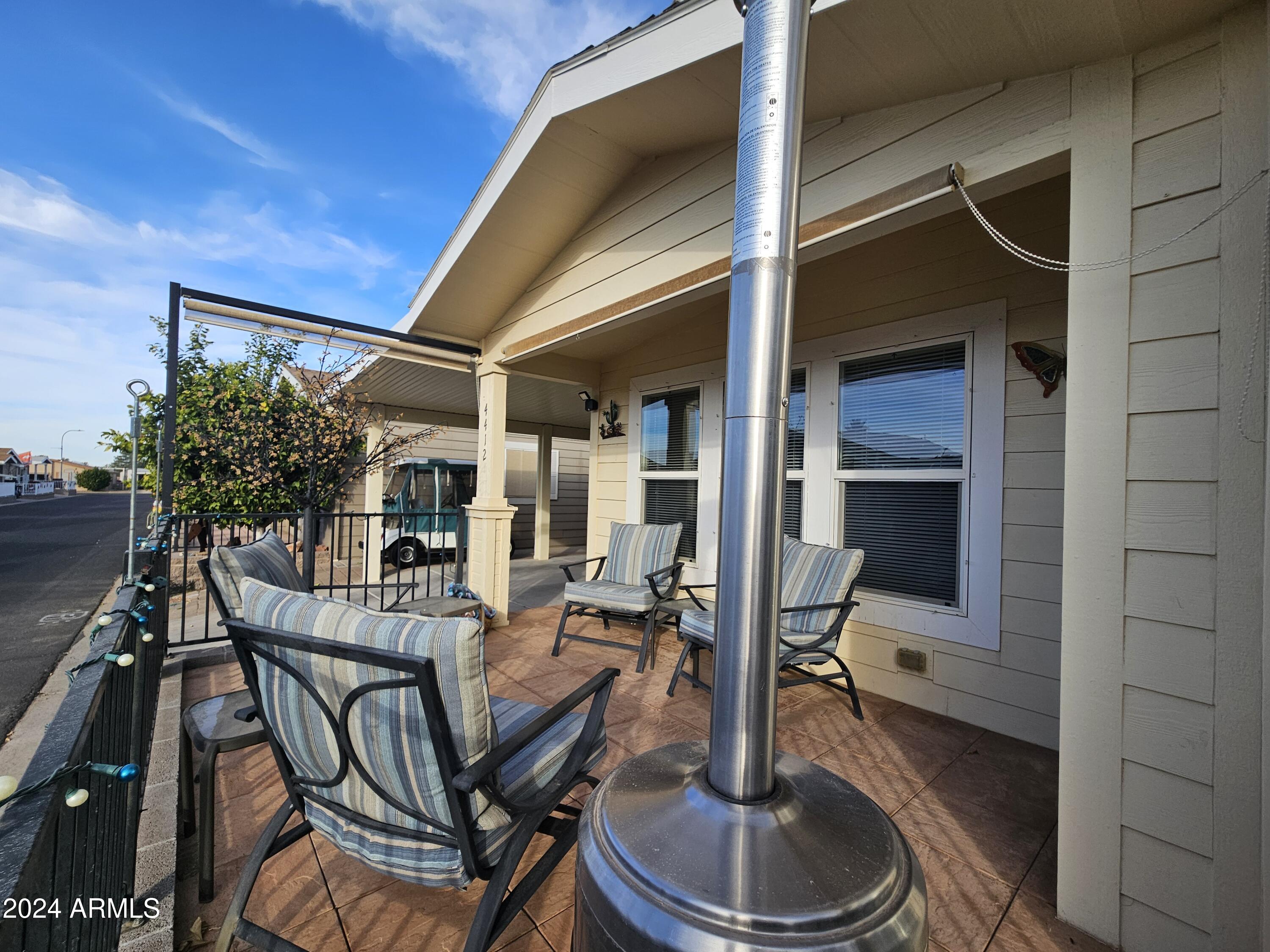 650 North Hawes Road, Unit 4412 Mesa, AZ 85207 - Photo 34 of 48 a patio with table and chairs and potted plants