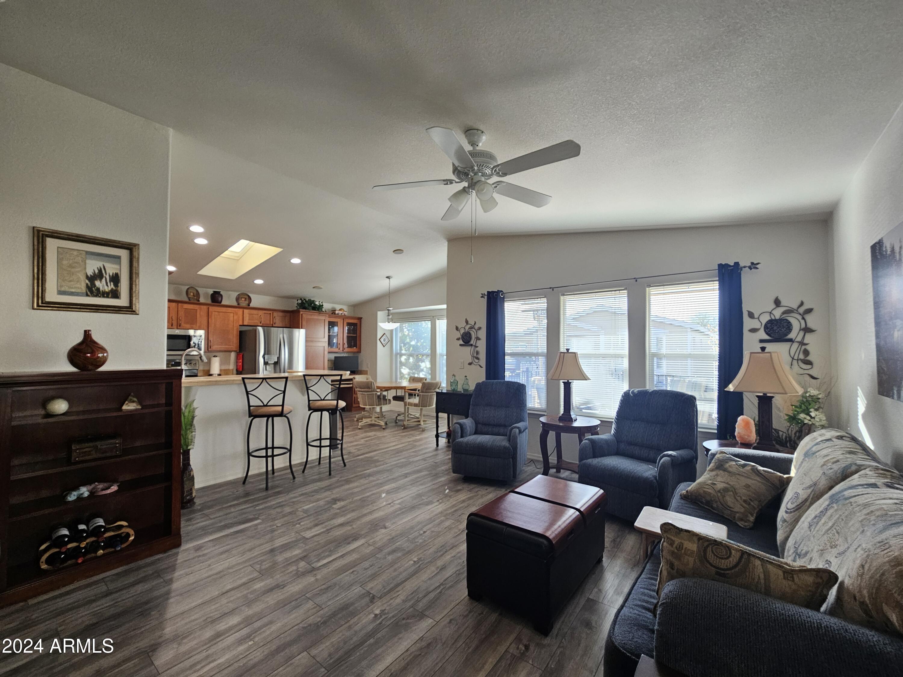 650 North Hawes Road, Unit 4412 Mesa, AZ 85207 - Photo 4 of 48 a living room with furniture a ceiling fan and a window