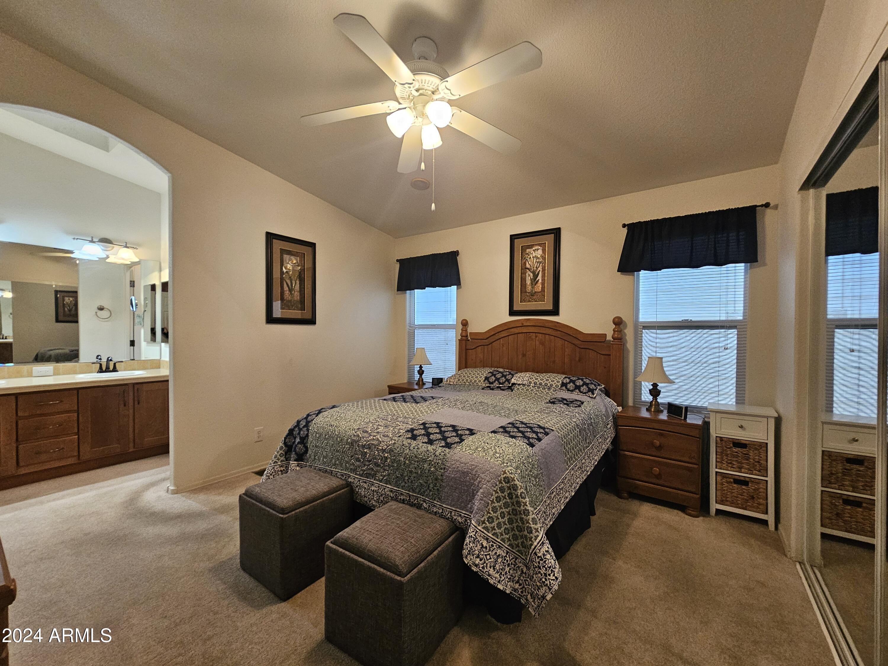 650 North Hawes Road, Unit 4412 Mesa, AZ 85207 - Photo 5 of 48 a spacious bedroom with a bed a window and a dresser