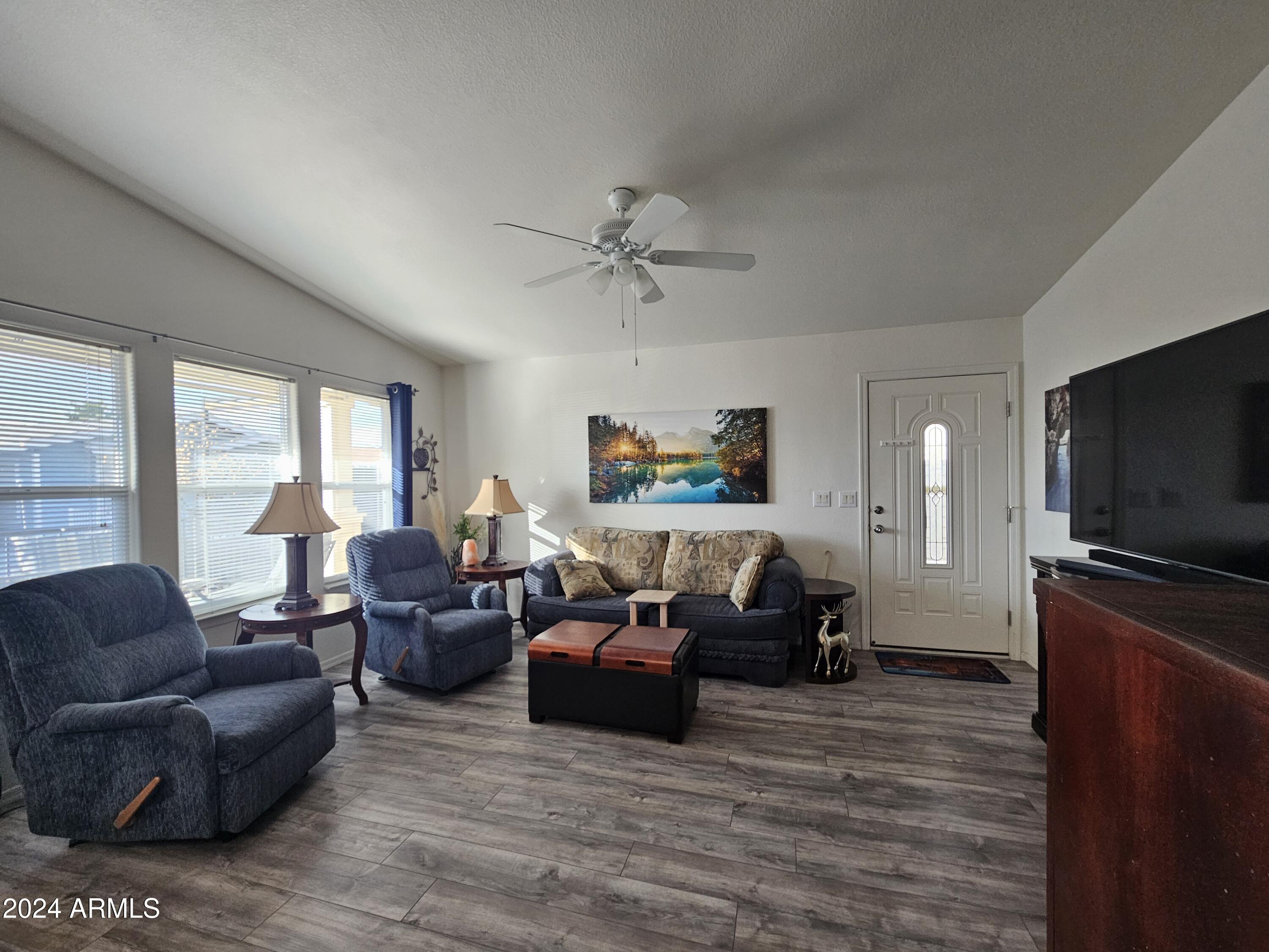 650 North Hawes Road, Unit 4412 Mesa, AZ 85207 - Photo 6 of 48 a living room with furniture and a flat screen tv