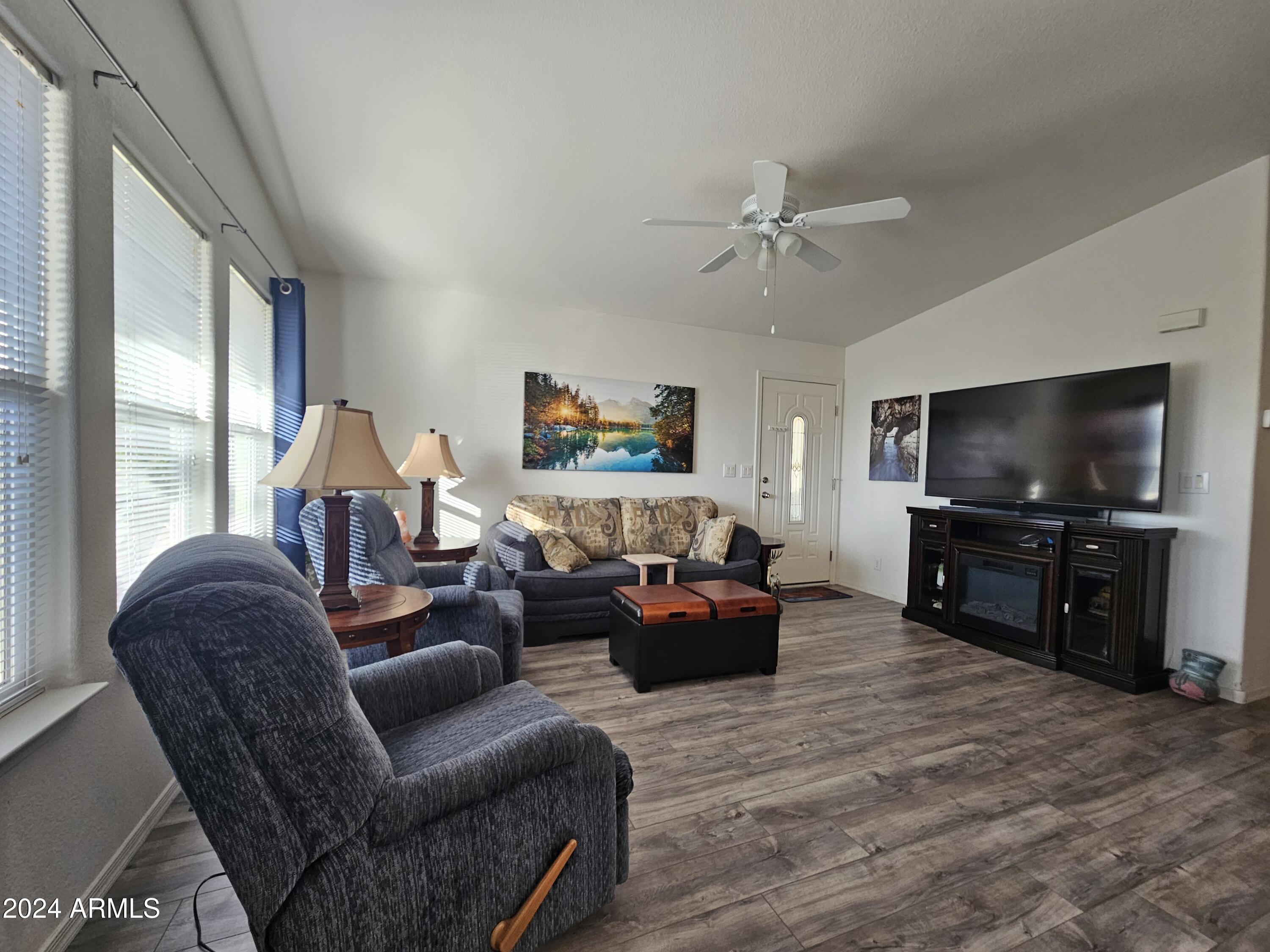 650 North Hawes Road, Unit 4412 Mesa, AZ 85207 - Photo 8 of 48 a living room with furniture and a flat screen tv