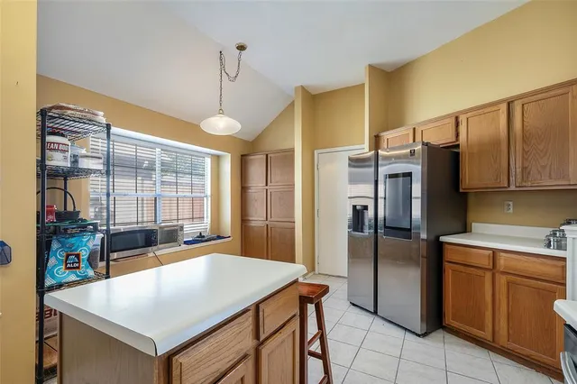 a kitchen that has a cabinets a sink and a refrigerator