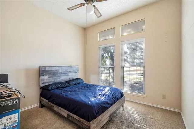 a spacious bedroom with a bed and a window