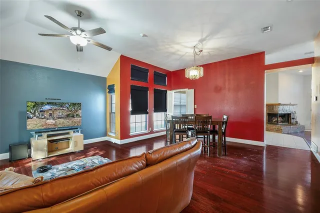 a living room with furniture a fireplace and a table
