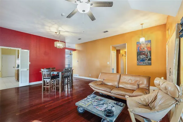 a living room with furniture and wooden floor