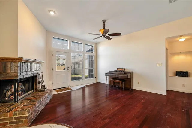a view of an empty room with furniture wooden floor and window