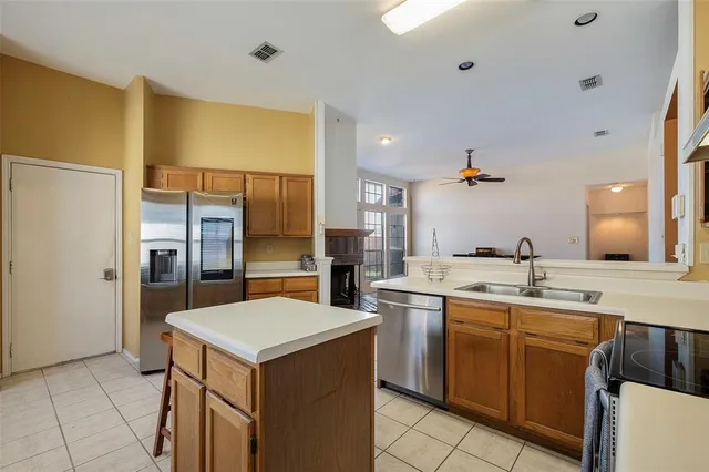 a kitchen with a sink and refrigerator