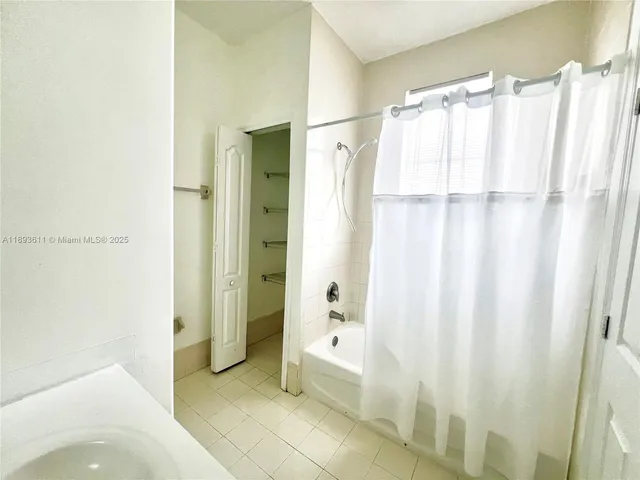 a street view with flower garden and wooden fence