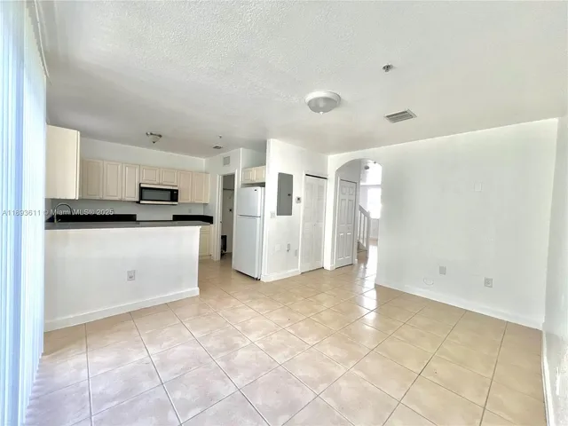 a view of a kitchen with white cabinets