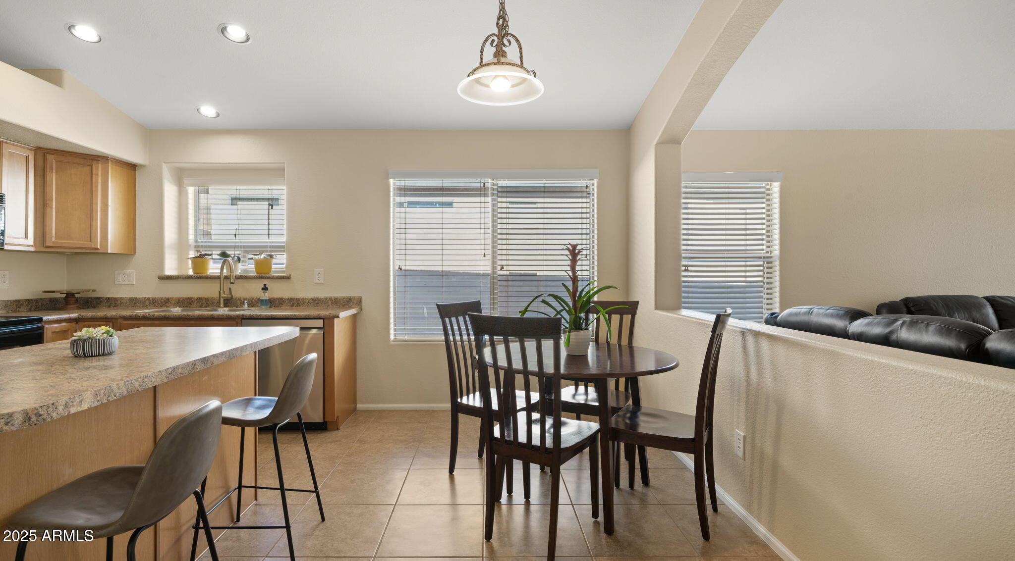 2215 West Peak View Road Phoenix, AZ 85085 - Photo 14 of 51 a view of a dining room with furniture and wooden floor