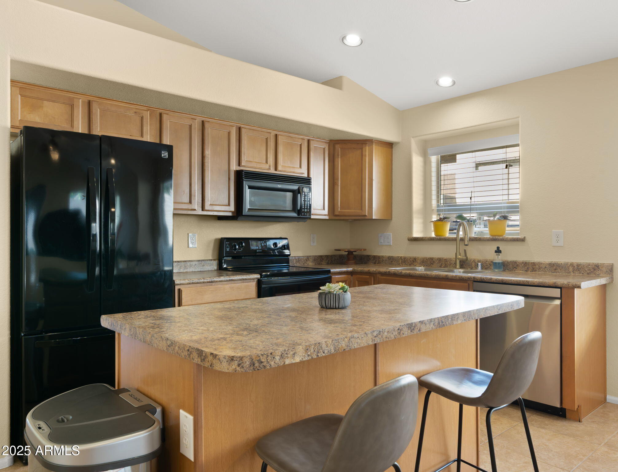 2215 West Peak View Road Phoenix, AZ 85085 - Photo 15 of 51 a kitchen with granite countertop a sink stove and refrigerator