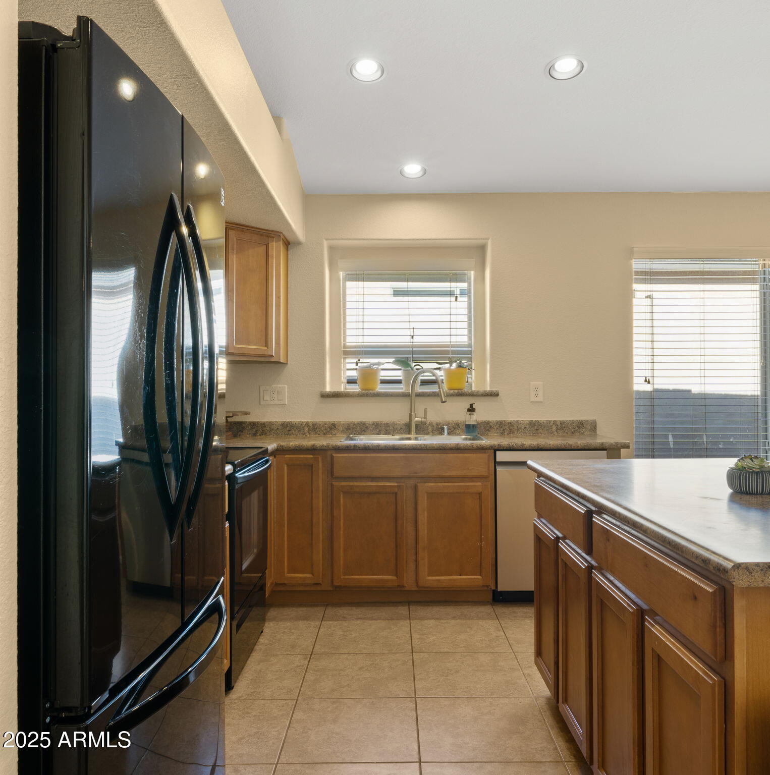 2215 West Peak View Road Phoenix, AZ 85085 - Photo 16 of 51 a kitchen with stainless steel appliances granite countertop a sink stove and refrigerator