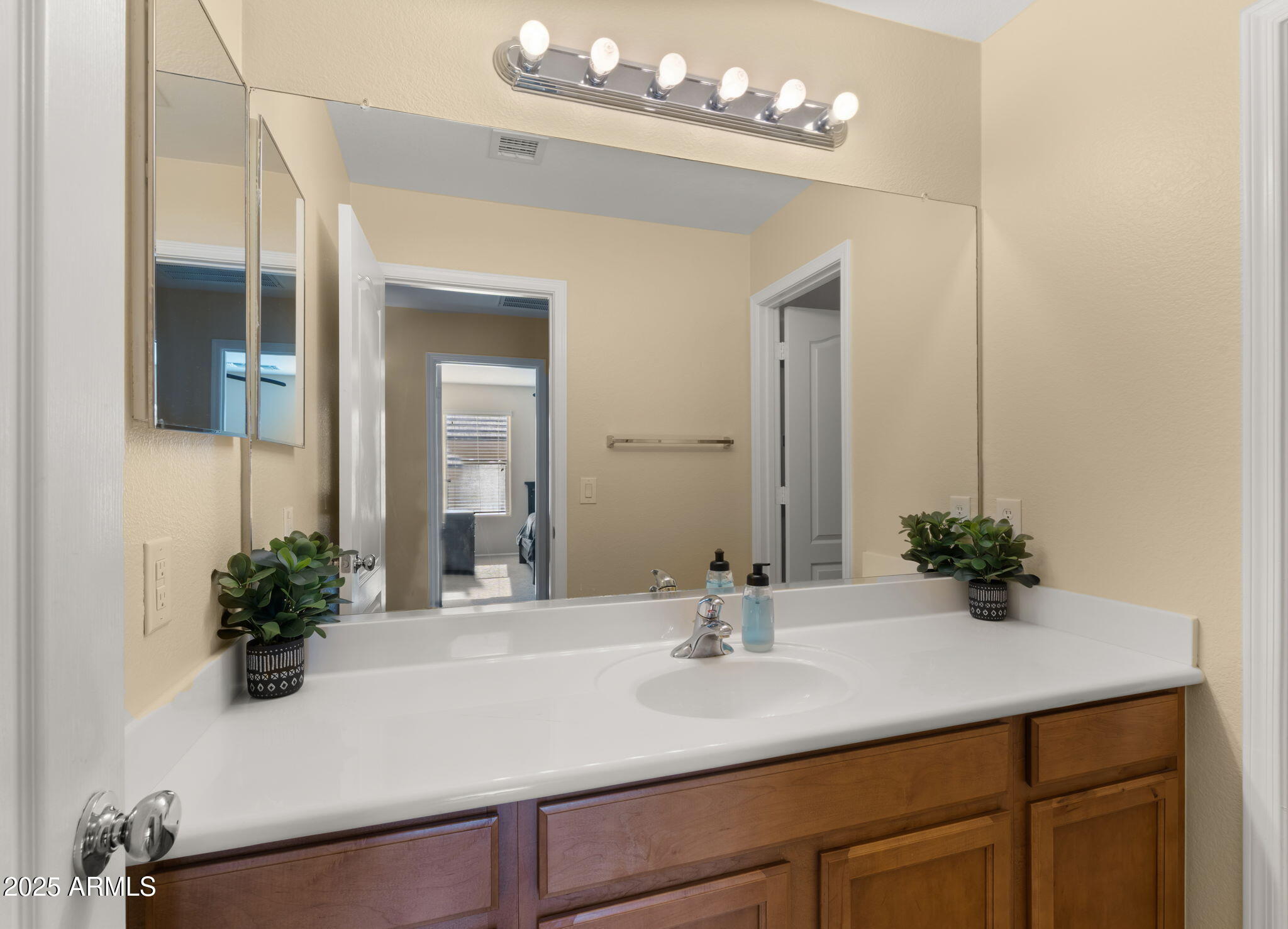 2215 West Peak View Road Phoenix, AZ 85085 - Photo 23 of 51 a bathroom with a sink a large mirror and vanity